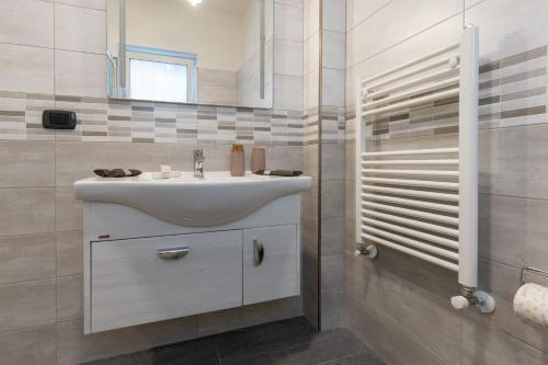 a bathroom with a white sink and a shower at Light stadium in Taormina