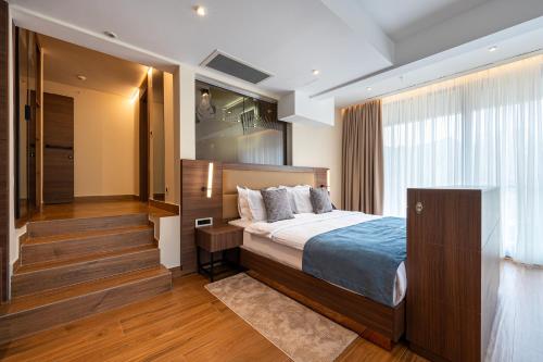 a hotel room with a bed and a staircase at Hotel De‘Andros Virpazar in Virpazar