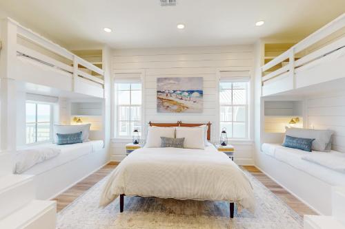 a bedroom with two beds and two windows at Palmilla Beach Sunrise Dreams in Port Aransas