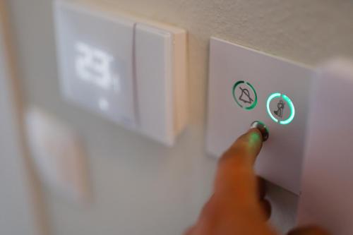 a person hitting a light switch with a finger at Oktolia suites in Alexandroupoli