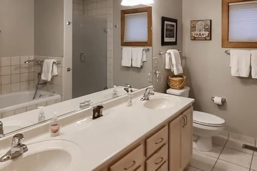 a white bathroom with a sink and a toilet at Mountain Retreat in South Fork