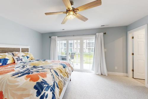 a bedroom with a bed and a ceiling fan at Sandy Cove --- 30184 Jump Ln in Ocean View
