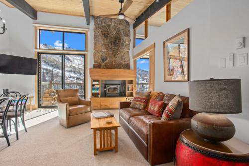 a living room with a couch and a table at Heated Pool and Hot Tub, Ski In, Ski Out, Top Level Unit, -Remodeled Fall 2022- in Steamboat Springs