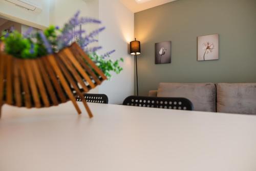 a bench in a living room with a couch at Oktolia suites in Alexandroupoli
