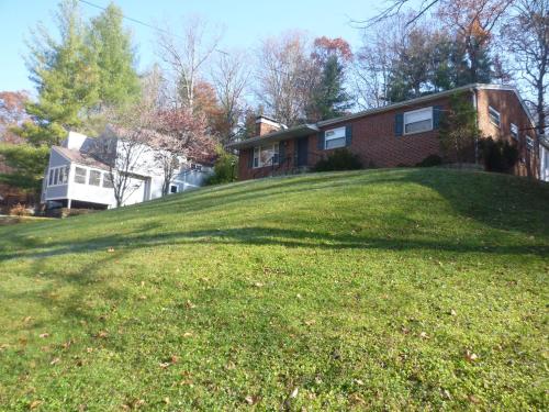a house on top of a grassy hill at Comfy Room in Huntington