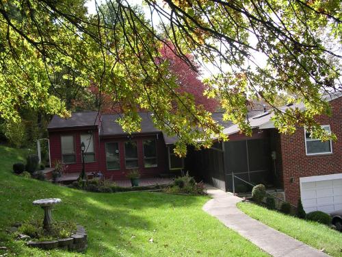 a red brick house with a green yard at Comfy Room in Huntington