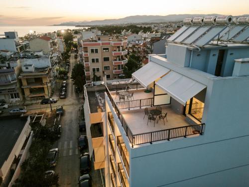 a view of a building with a balcony with a table at Oktolia suites in Alexandroupoli