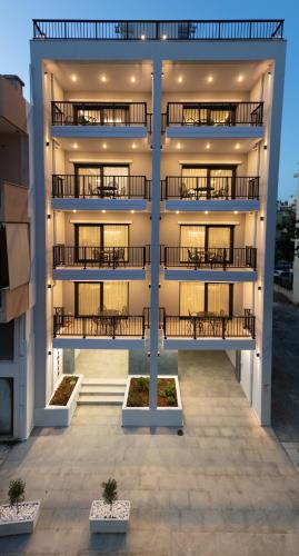 an apartment building with balconies on the side of it at Oktolia suites in Alexandroupoli