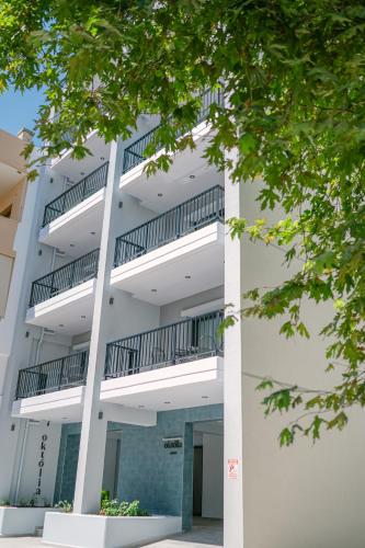 an external view of an apartment building with balconies at Oktolia suites in Alexandroupoli