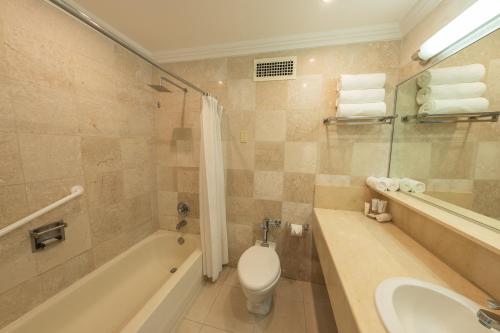 a bathroom with a tub and a toilet and a sink at Hotel El Panama by Faranda Grand, a member of Radisson Individuals in Panama City