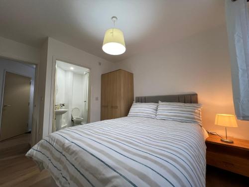 a bedroom with a large bed and a light at Kilnview Guesthouse-Hanley & Staffordshire University in Stoke on Trent