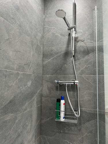 a shower with a shower head in a bathroom at Kilnview Guesthouse-Hanley & Staffordshire University in Stoke on Trent