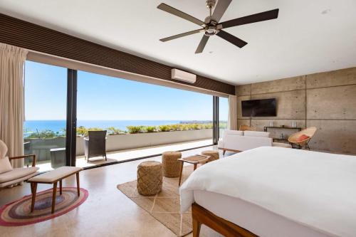 a bedroom with a bed and a large window at Near Punta Mita - Gorgeous Modern Villa in Higuera Blanca