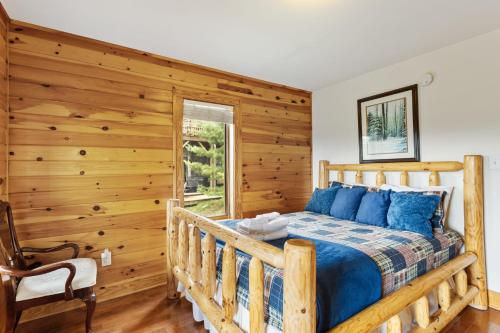 a bedroom with a bed and a wooden wall at Mountain Heir in Fleetwood