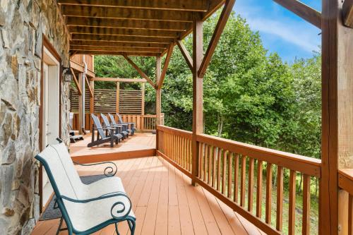 a porch with chairs and a stone wall at Mountain Heir in Fleetwood