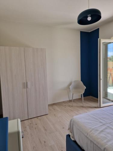 a bedroom with a bed and a cabinet and a chair at marte rooms in Centola