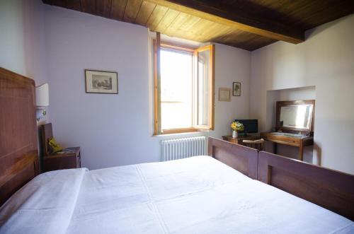 a bedroom with a large bed and a window at Agriturismo Ca'de'Gatti in Faenza