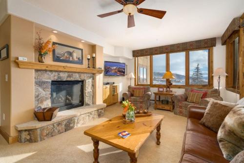 a living room with a couch and a fireplace at Pool and Hot Tubs, Private Washer & Dryer, Creekside Base Area Location in Steamboat Springs