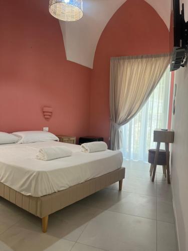 a bedroom with two beds and a large window at Casa mia MadamA in Gaeta