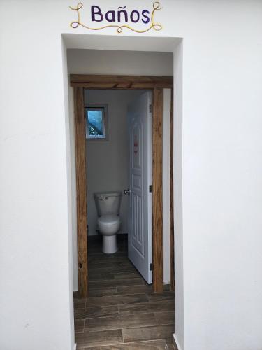 a bathroom with a toilet in a hallway at Bella Villa room with large pool and close to beach in Las Galeras