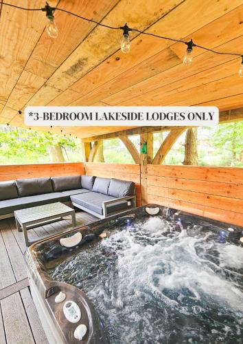a hot tub in the middle of a wooden house at Hay's Wood Retreat - Holiday Lodges in North Runcton