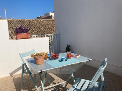 a table and two chairs sitting on a patio at La Casa di Pippo in Augusta