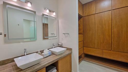 a bathroom with two sinks and a mirror at Palacio Huatulco - 5C in Santa Maria Huatulco