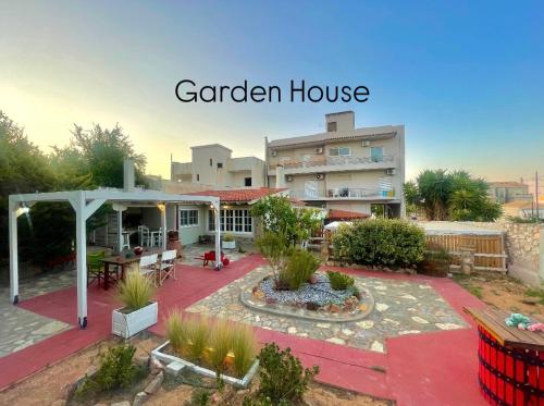 a garden house with a patio and a building at Aggelou Apartments in Spáta