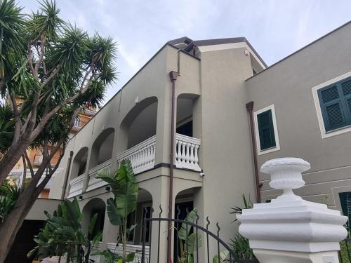 a large white building with a white statue in front of it at Villa Marina in Marina dʼAndora