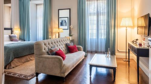 a living room with a couch and a bed at InterContinental Porto - Palacio das Cardosas by IHG in Porto