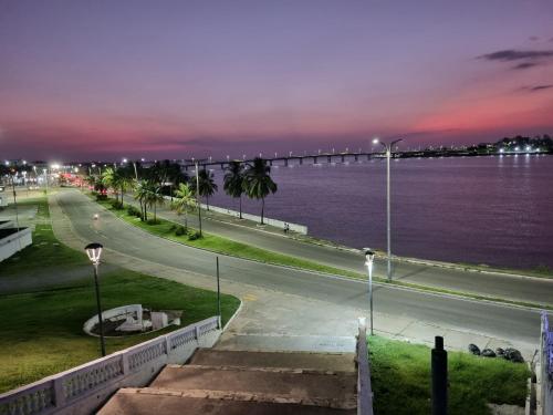 a bridge over the water at night at Suíte Cama Queen perto Centro Histórico e Praias in São Luís