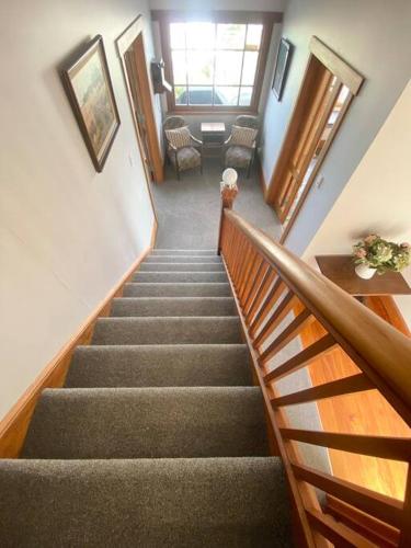 a stairway in a building with stairs and chairs at Spectacular View atop Napier Hill - Space for all! in Napier