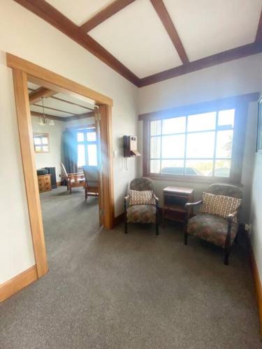 a room with chairs and a table and a window at Spectacular View atop Napier Hill - Space for all! in Napier