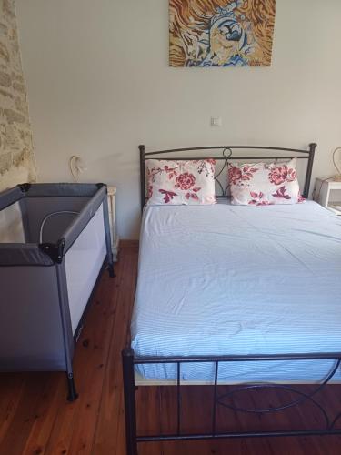 a bedroom with a bed with pink pillows on it at casa zervos - Abode of Light in Loutraki