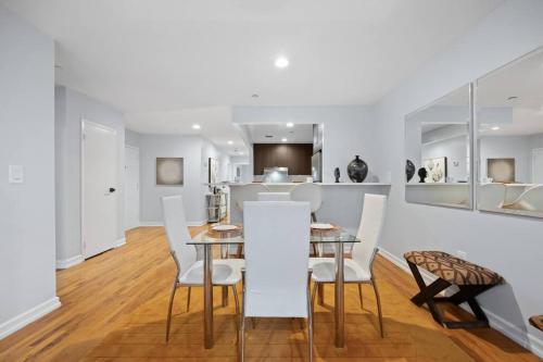 a dining room and kitchen with white walls and a table and chairs at The Lenox in New York
