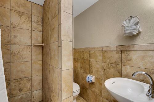 a bathroom with a toilet and a sink at Water View & Heated Pool - Steps to Sand, Bayview Beauty B-5 in Clearwater Beach