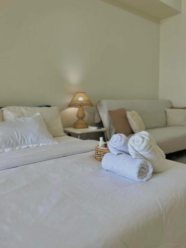 a hotel room with two towels on a bed at Lake View Wind SMDC Tagaytay in Tagaytay