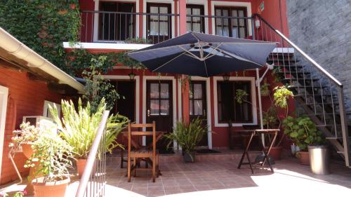 a blue umbrella sitting in front of a building at Hotel Rivera in Colonia del Sacramento