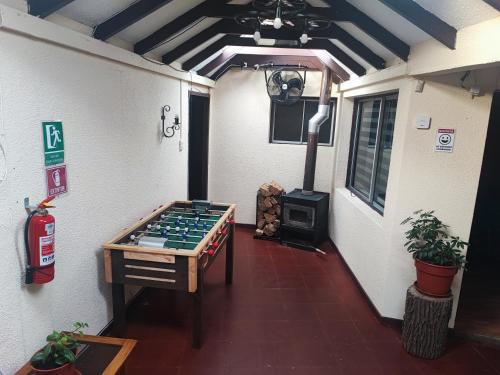 a room with a chess board and a wood stove at Hostal Fernanda in Santa Cruz