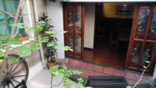 an entrance to a house with doors and plants at Hotel Rivera in Colonia del Sacramento