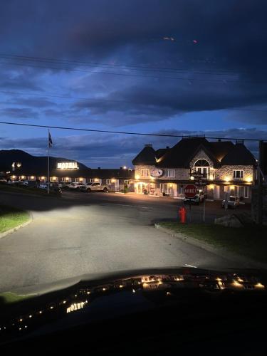 an empty street at night with a house at Motel Belvedere in Saint-Siméon