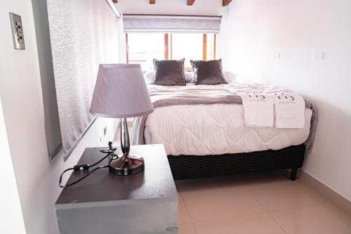 a bedroom with a bed and a table with a lamp at home 333 loft 334 in Escazu