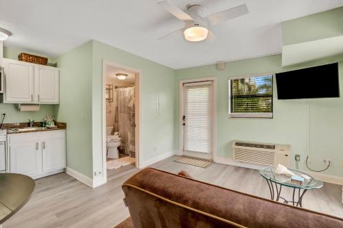 a living room with a couch and a kitchen at Sunset Corner - Beach View & Heated Pool! in St Pete Beach