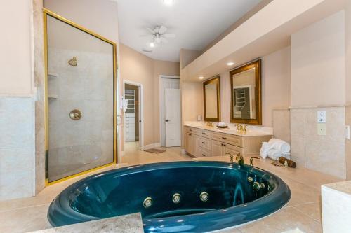a large blue tub in a bathroom with a shower at Sweet Escape - Monthly Beach Rental in Clearwater Beach