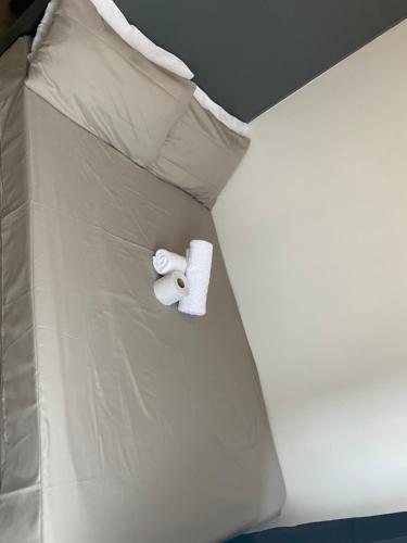 a bed with a roll of toilet paper on it at Casa Bella at Sea Residences MOA in Manila