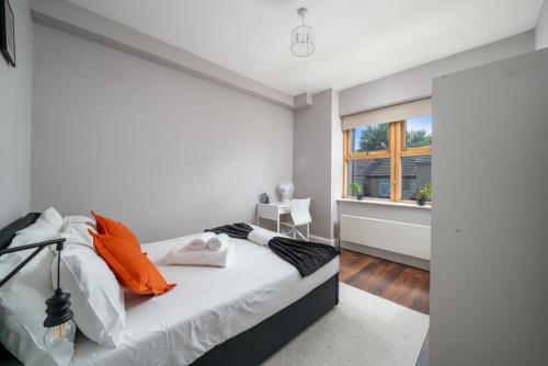 a white bedroom with a bed and a window at Watford Junction 2 bedrooms Apartment, Free,Parking, Warner Bro nearby -15 mins to Central London in Watford