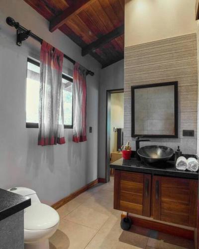 a bathroom with a sink and a toilet at Modern Two Story Beach house in Puerto Viejo