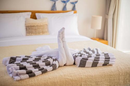 a bedroom with a bed with two towels on it at Alas Villa - 3 Bedrooms Private Pool Villa in Nusa Lembongan