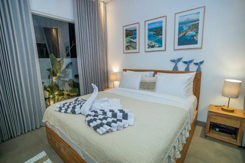 a bedroom with a bed with towels on it at Alas Villa - 3 Bedrooms Private Pool Villa in Nusa Lembongan