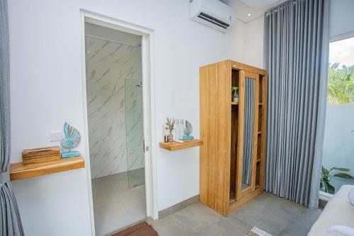 a room with a glass door leading into a room at Alas Villa - 3 Bedrooms Private Pool Villa in Nusa Lembongan
